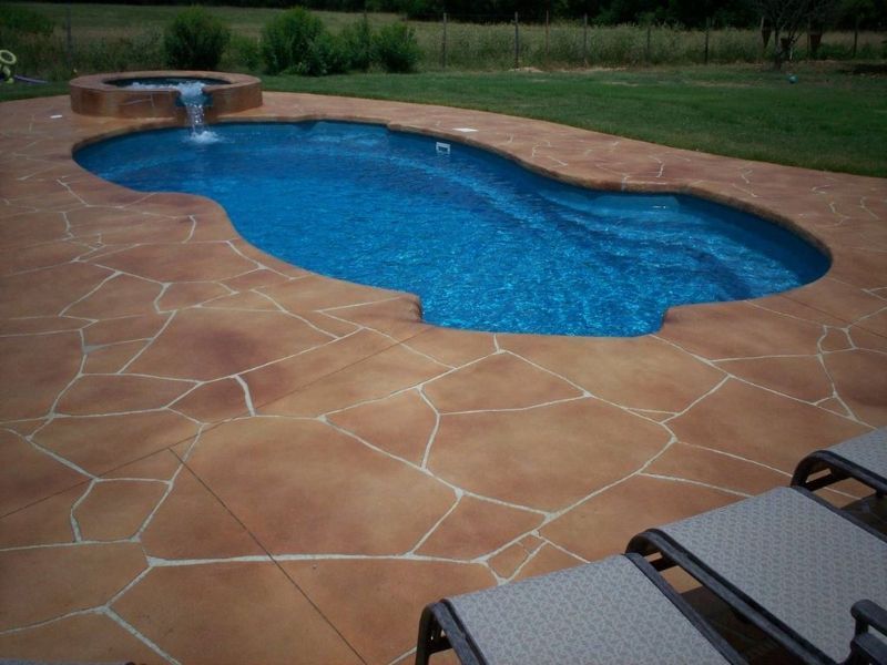 A large swimming pool with a waterfall in the middle