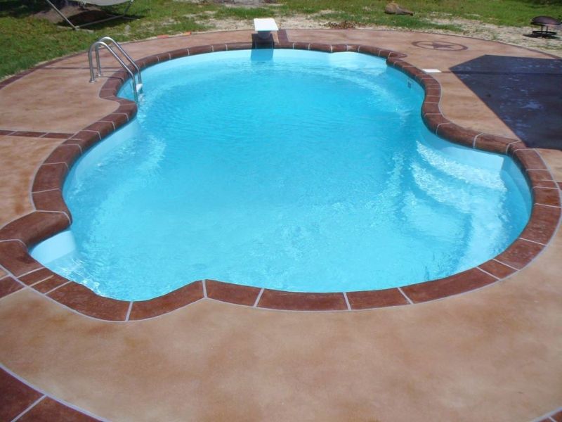 A large swimming pool with a staircase leading to it