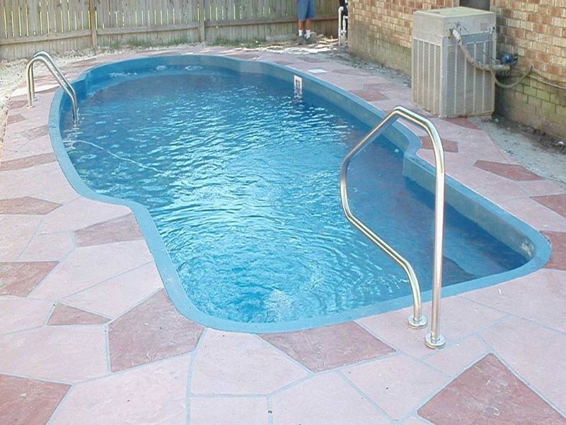 A large swimming pool with stairs leading to it