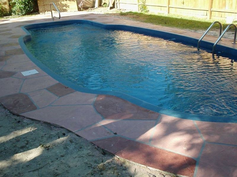 A large swimming pool with stairs leading to it
