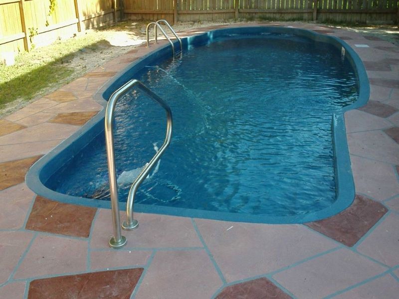 A swimming pool with a staircase leading to it