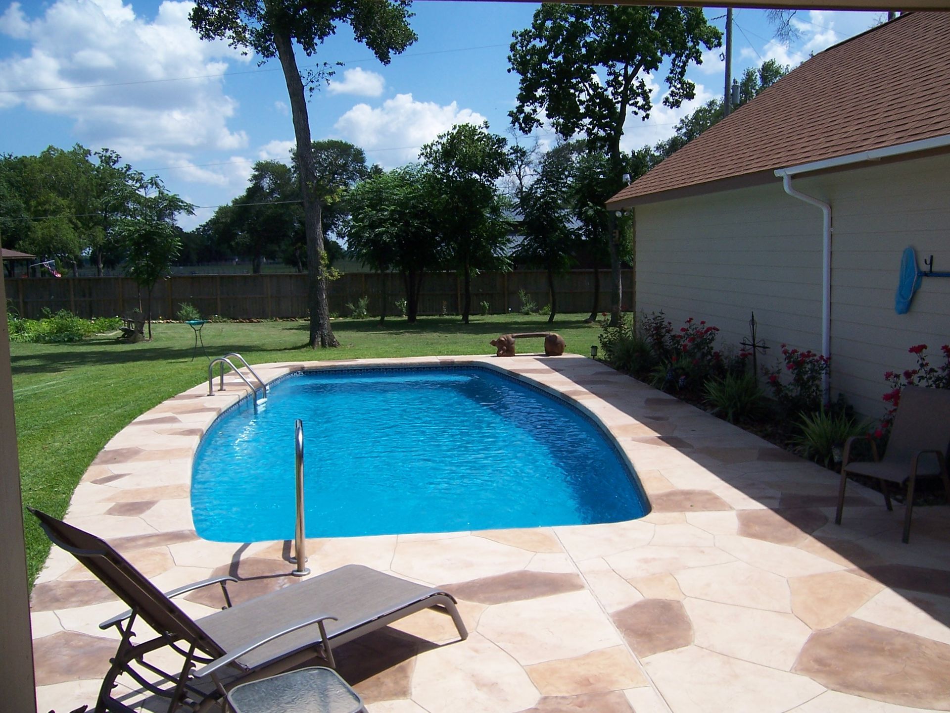 A small swimming pool in the backyard of a house