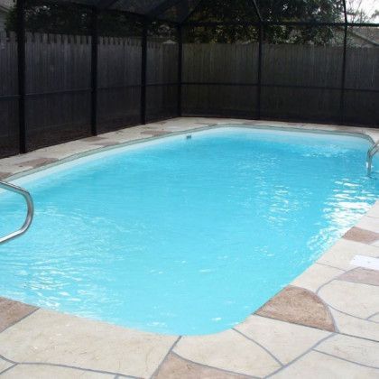 A large swimming pool with a fence surrounding it