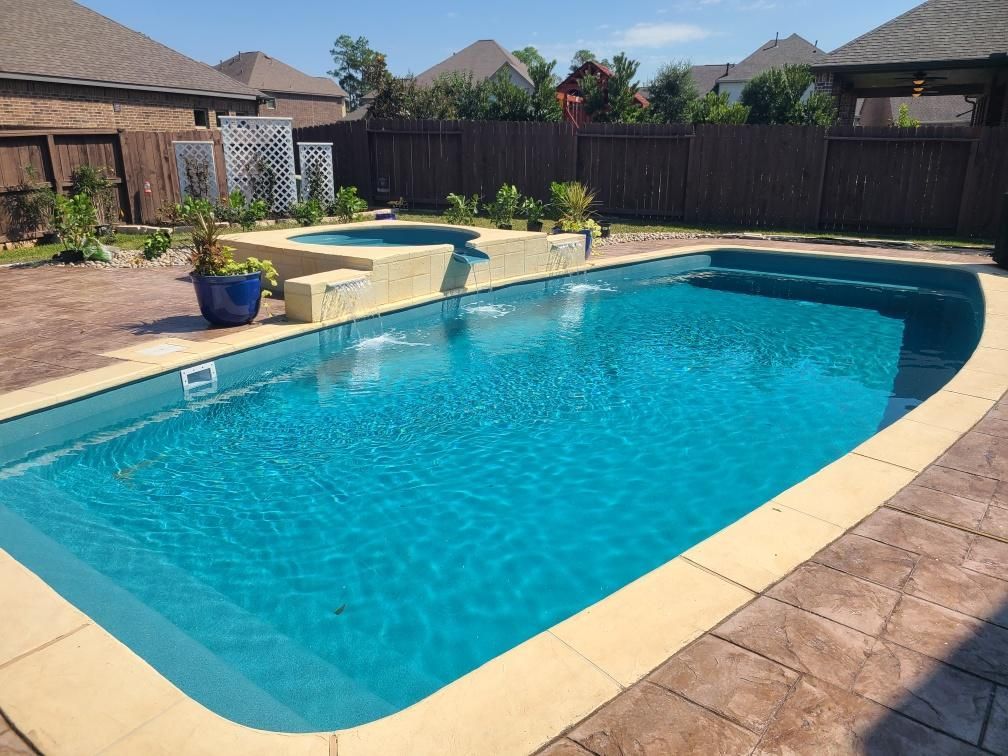 A large swimming pool in the backyard of a house
