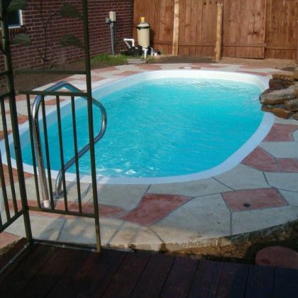 A swimming pool is surrounded by a wooden fence