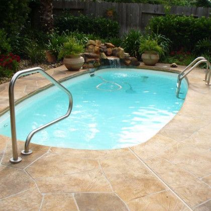 A small swimming pool with a waterfall in the background