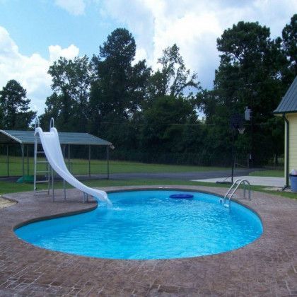A swimming pool with a slide in the middle of it