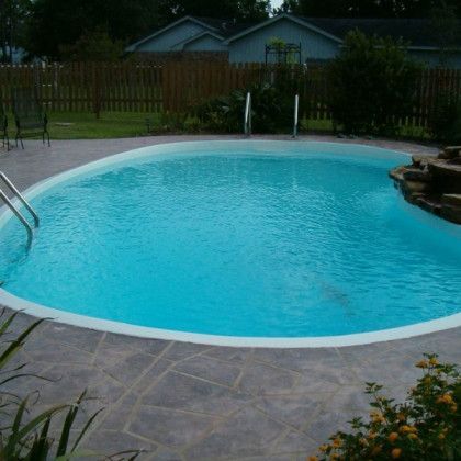 A large swimming pool with a staircase leading to it