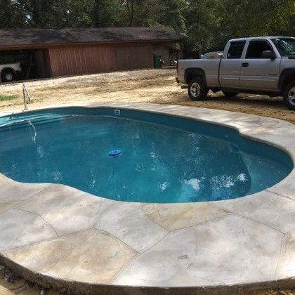 A truck is parked next to a swimming pool.