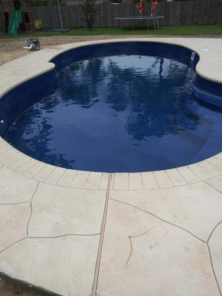 A large blue swimming pool with a white border