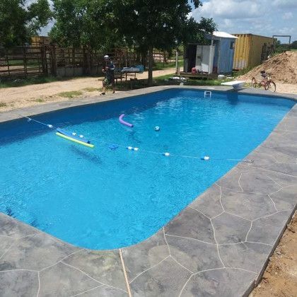 A large swimming pool with a bicycle in the background