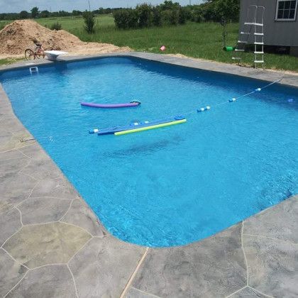 A large swimming pool with a ladder and floats in it