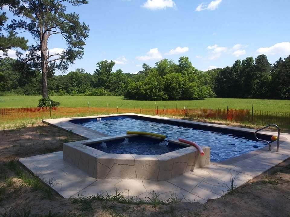 A large swimming pool in the middle of a field