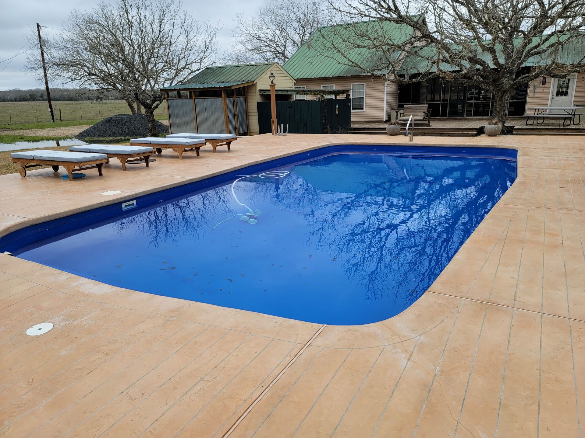 A large swimming pool with a slide in the background