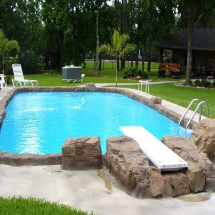 A large swimming pool with a diving board in the middle