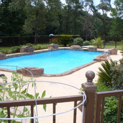 A large swimming pool with a fence around it