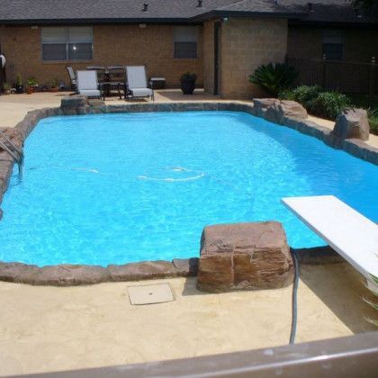 A large swimming pool in the backyard of a house