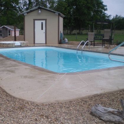 A large swimming pool with a shed in the background