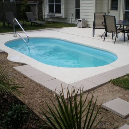 A small swimming pool in the backyard of a house