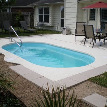 A small swimming pool in the backyard of a house