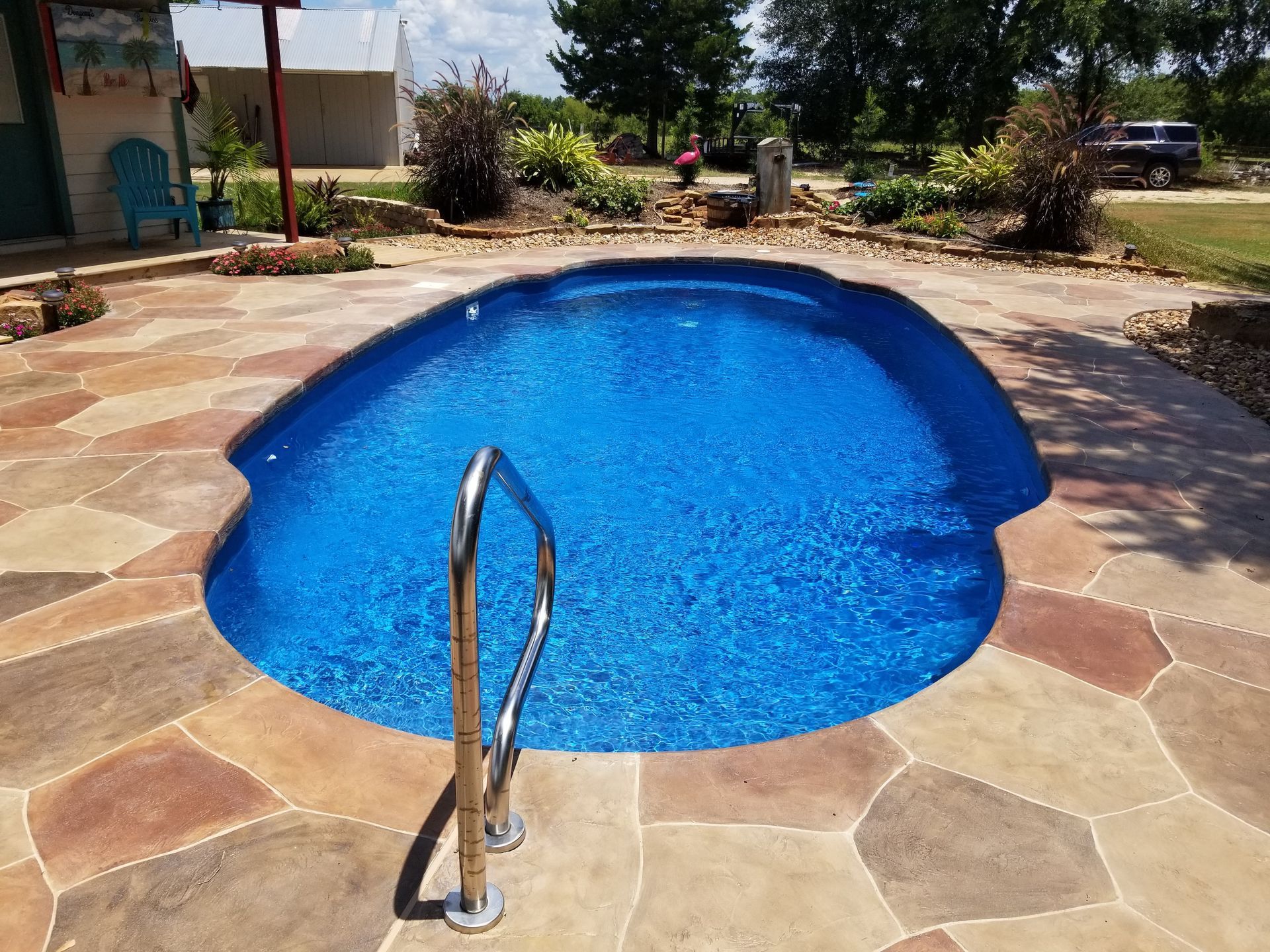 A large swimming pool with a staircase leading to it