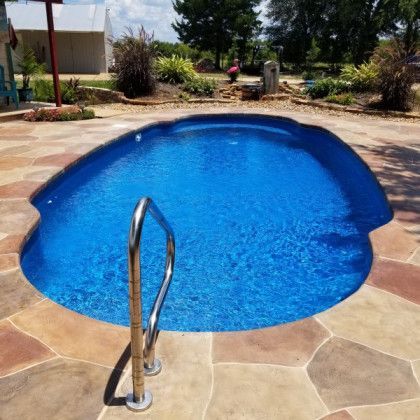 A large blue swimming pool with stairs leading to it