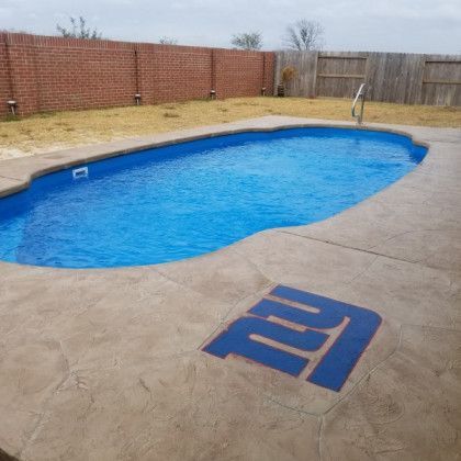 A swimming pool with a ny giants logo on the side