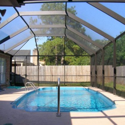A screened in swimming pool with a clear roof