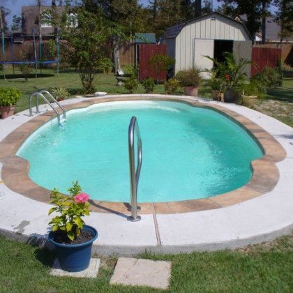 A swimming pool in a backyard with a shed in the background