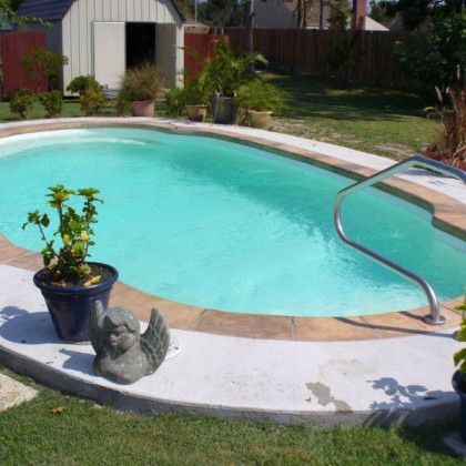 A swimming pool with a statue of an angel on the edge
