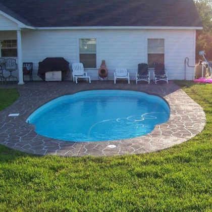 A white house with a swimming pool in front of it