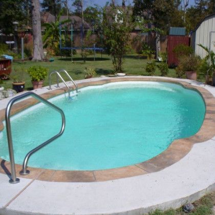 A large oval swimming pool with stairs leading to it