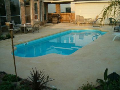 A large swimming pool in the backyard of a house