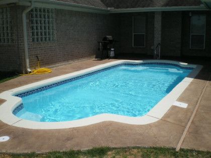 A large swimming pool in the backyard of a house