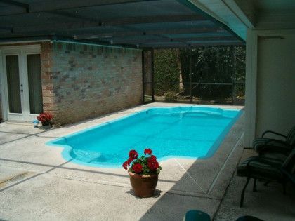 A swimming pool with a potted plant in front of it