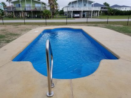 A small swimming pool with a staircase leading to it