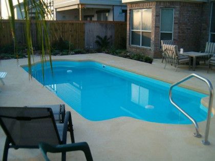 A large swimming pool in the backyard of a house