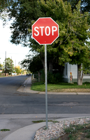 Three green signs on a pole with arrows pointing in different directions.
