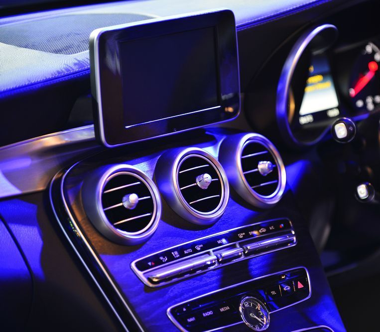 A Person Is Cleaning the Dashboard of A Car with A Cloth — Carline Automotive Solutions in Bungalow, QLD