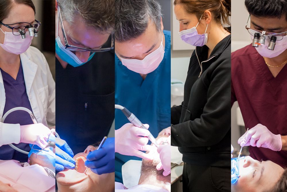 Dentist and assistant examine a patient's teeth in a dental office.