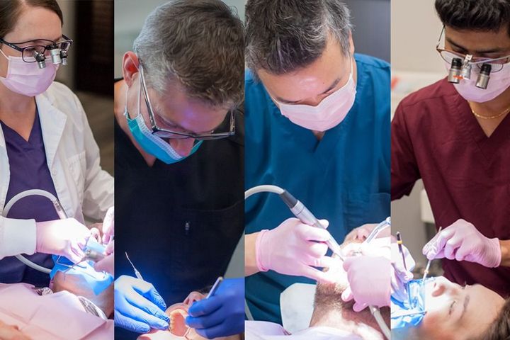 Dentist and assistant examine a patient's teeth in a dental office.