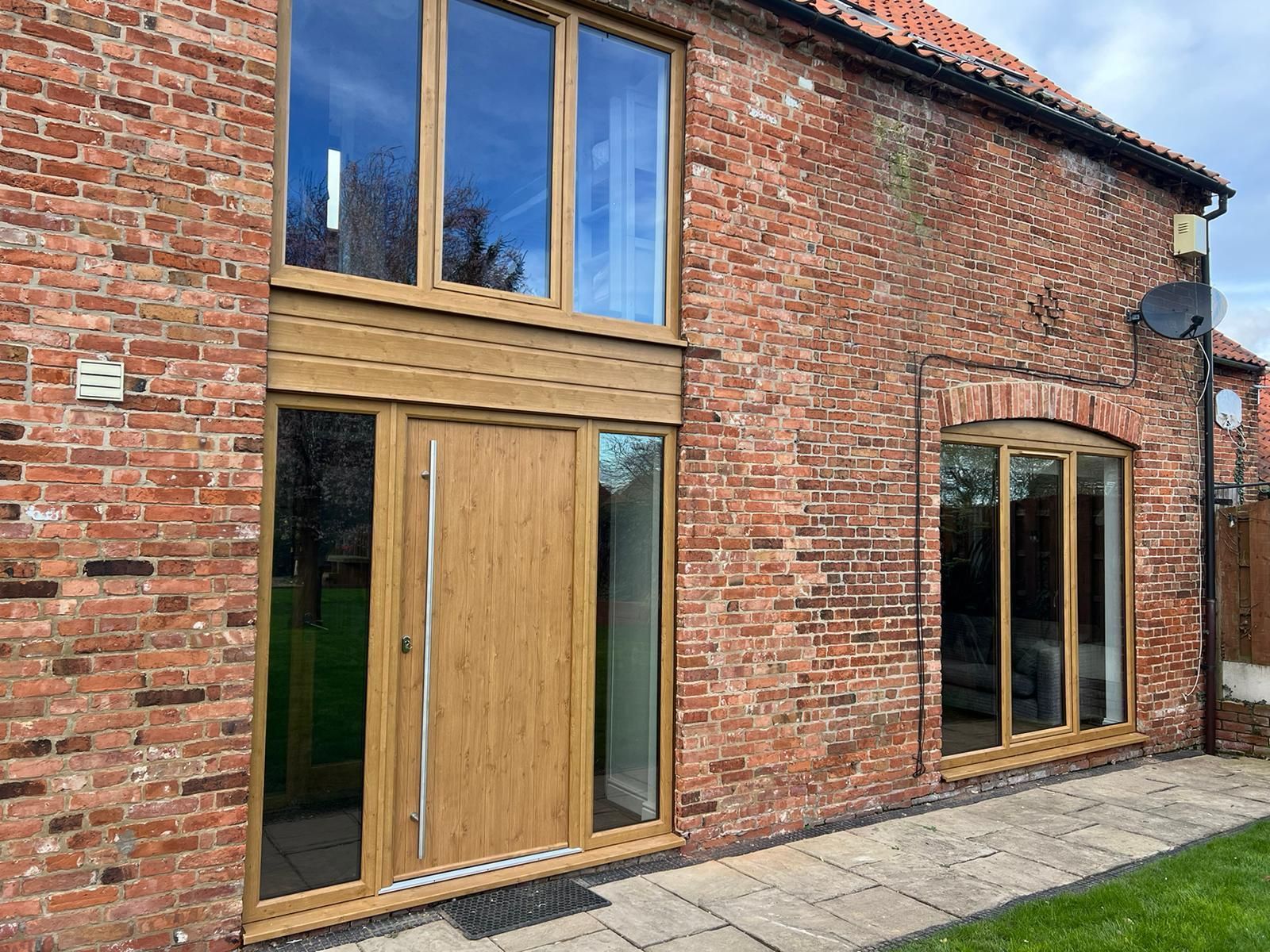 Red brick building with a composite door and double-glazed windows.