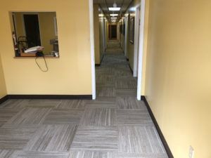 Hallway featuring newly installed carpet tile flooring for a commercial building in Plantation, FL.