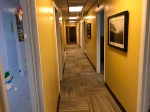 Commercial hallway with professional carpet tile installation by expert flooring contractors in Plantation, FL.
