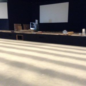 Finished commercial carpet installation in large auditorium by professional flooring team in Plantation, FL.
