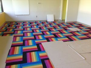 Bold and colorful carpet tile flooring installed in a creative commercial space in Plantation, FL.
