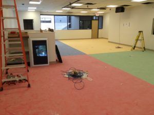 Multi-zone carpet tile layout being installed in a commercial space by flooring experts in Plantation, FL.