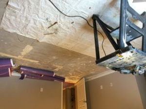 A ladder is sitting on the floor in a room.