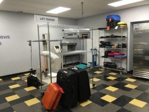 A room with a lot of luggage and a sign that says lift tester