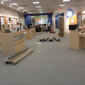Carpet installation underway in a commercial retail space by flooring professionals in Plantation, FL.